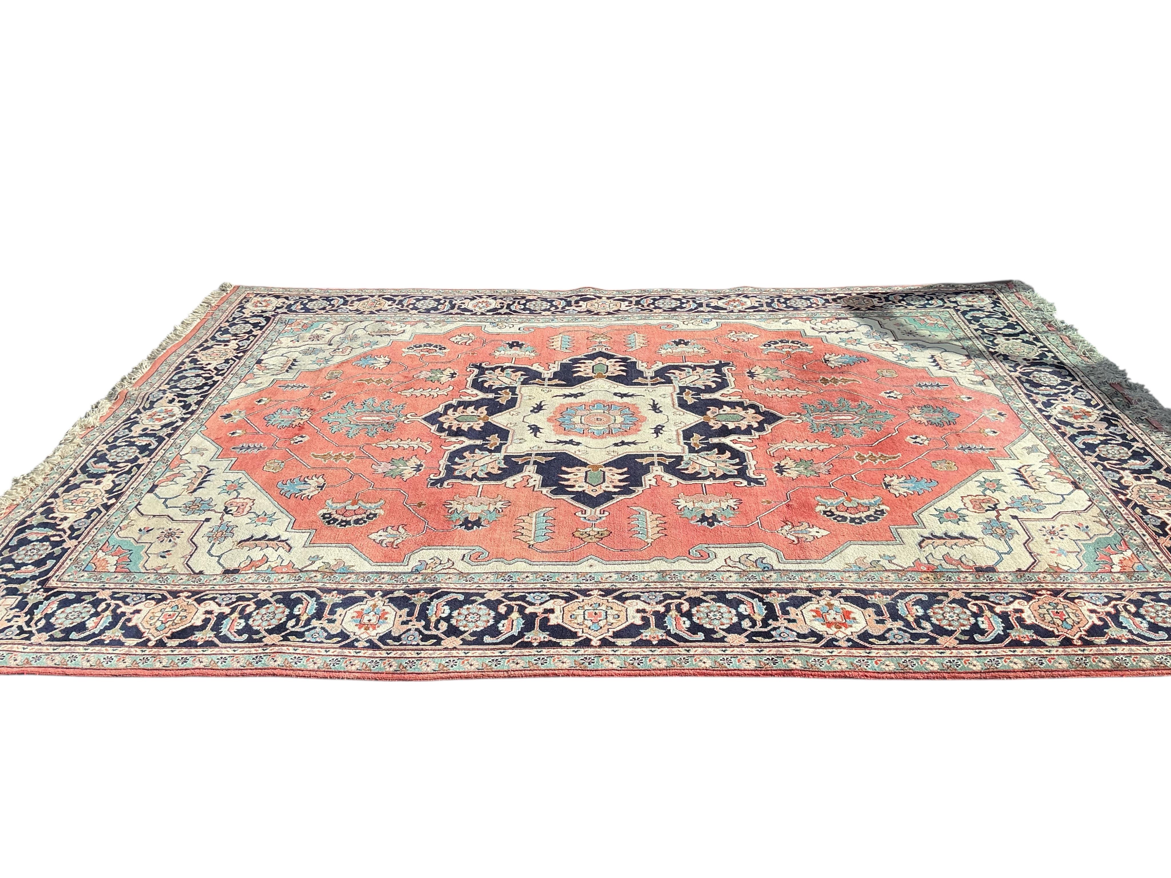 A Heriz brick red ground carpet, 360 x 266cm